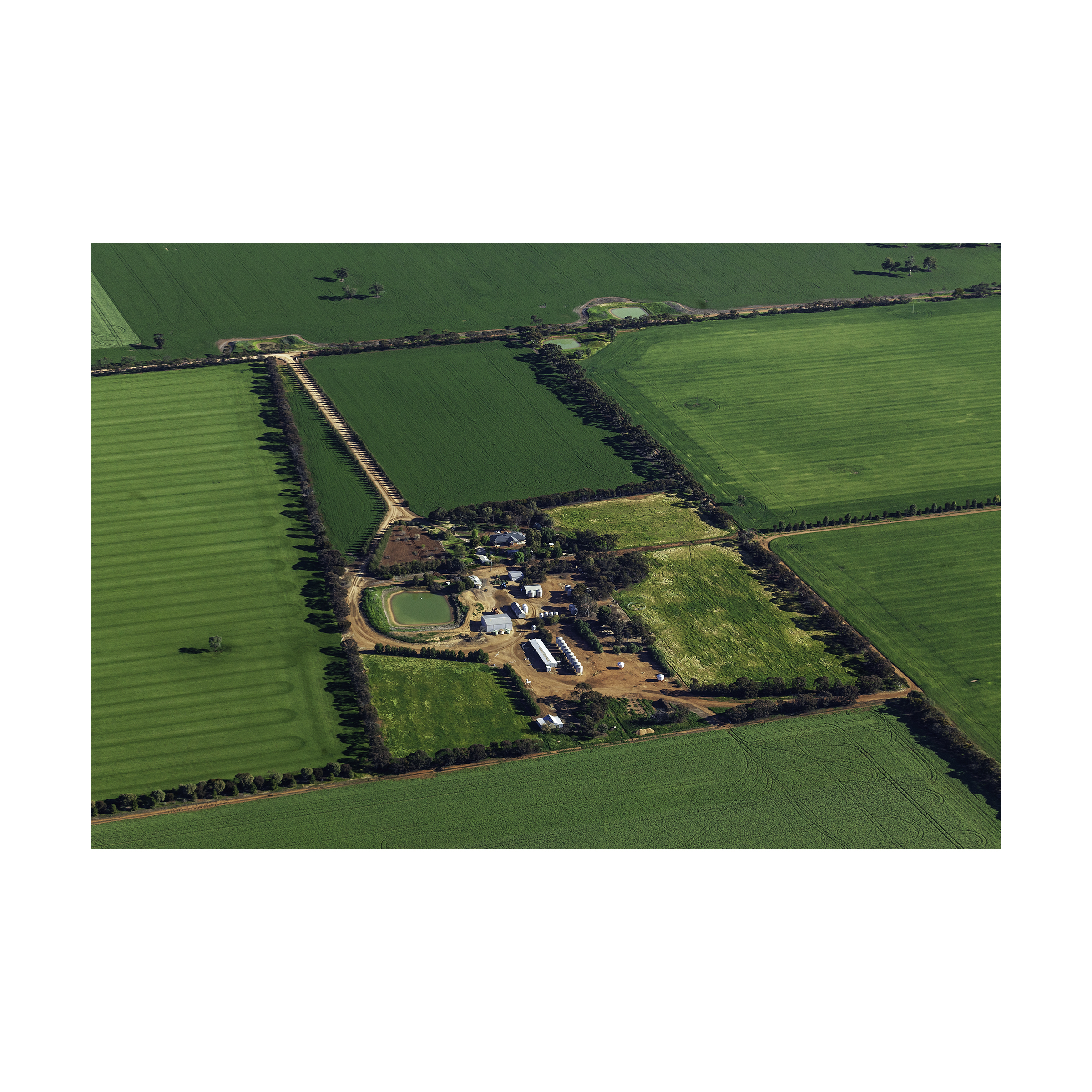 Bird's eye view of agricultural land in Victoria showing harvested grain fields and farm road network