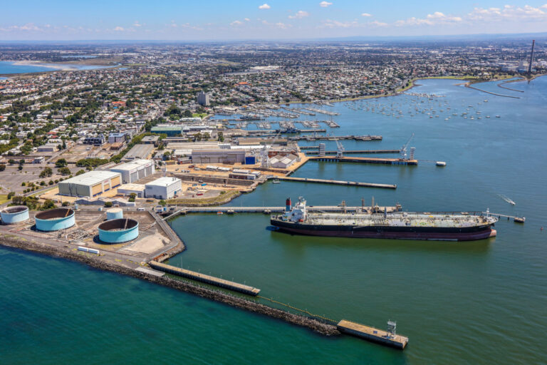 Aerial photography of Williamstown Melbourne VIC showing harbour, marina, industrial port infrastructure and surrounding coastal suburb captured from a fixed wing aircraft