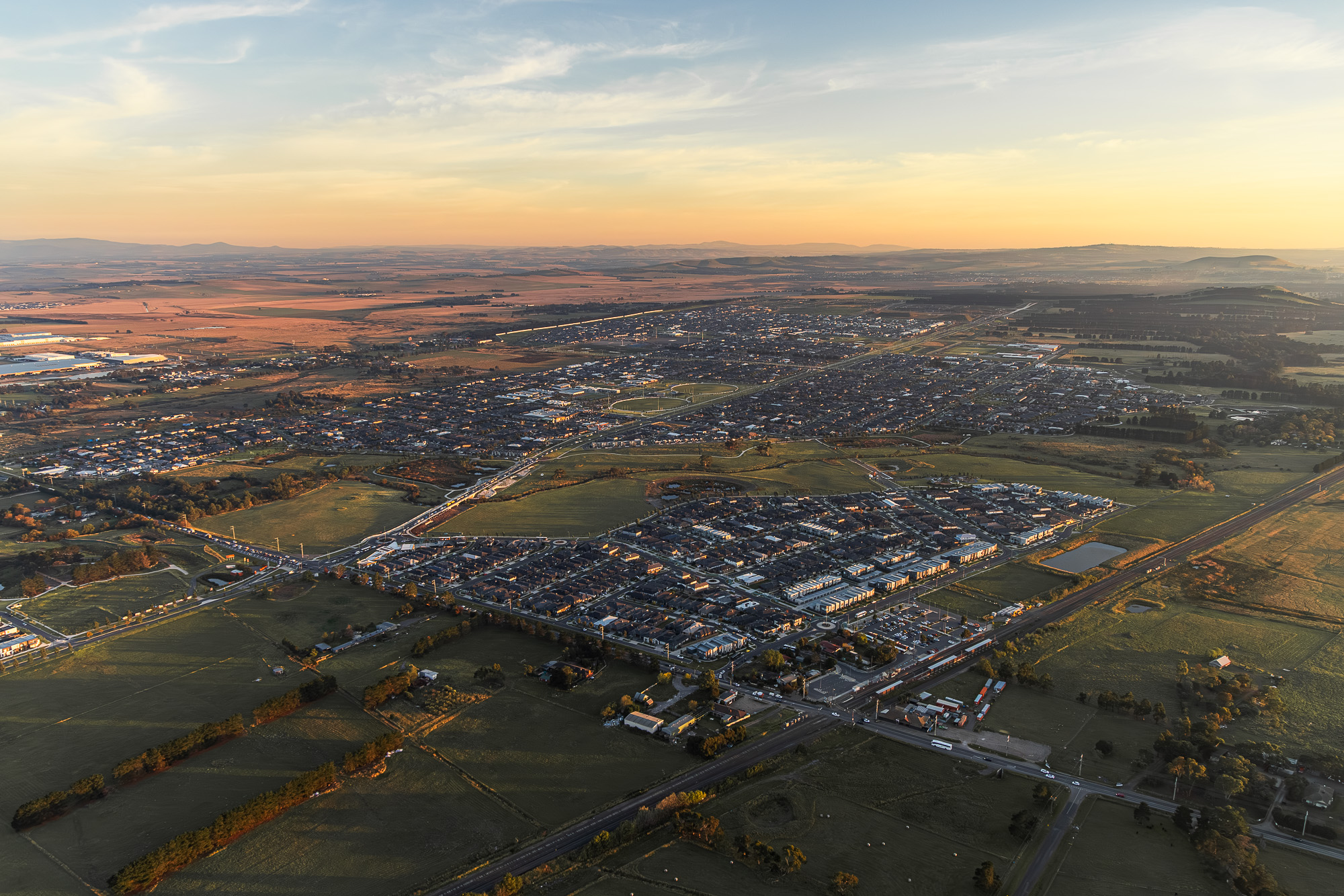 Helicopter aerial photography at sunrise over Kalkallo, north Melbourne — golden hour landscape from the air
