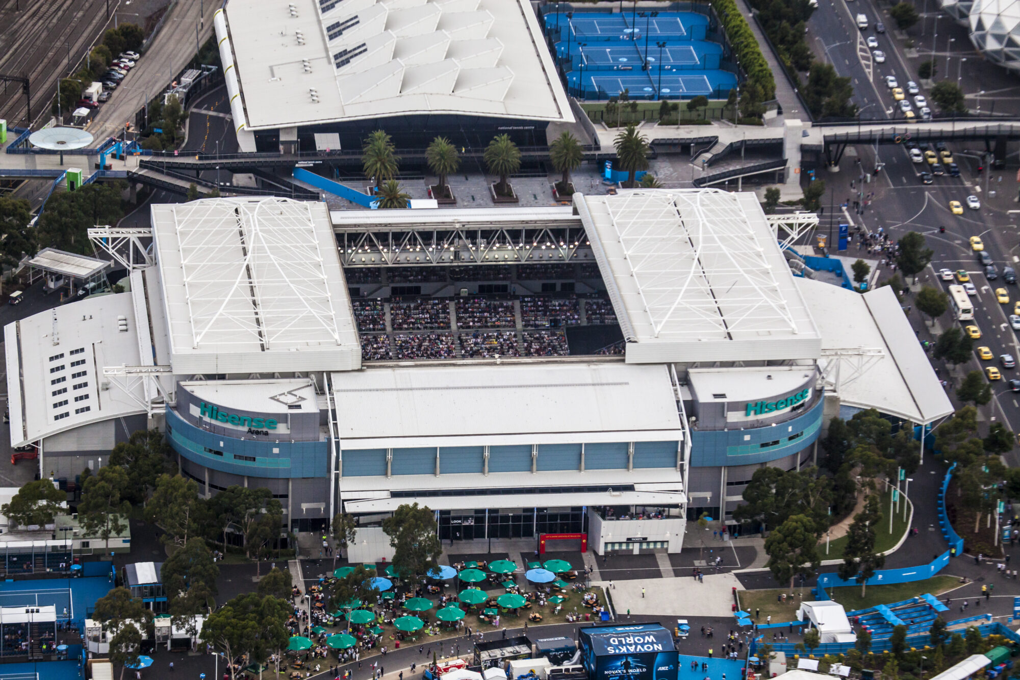 Aerial photograph of Hisense Arena during the Australian Open showing the open roof, crowd and surrounding precinct